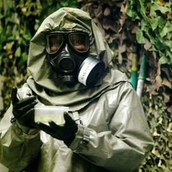 An instructor at the Fort Leonard Wood Chemical School carries the VX nerve agent.