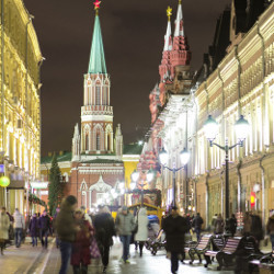 people walking on a street in Moscow at night