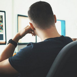 tech worker facing computer display