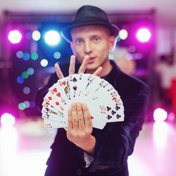 Magician spreads deck of cards in fan shape with one hand.