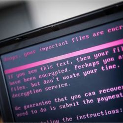 Computer screen displays threatening cyber attack message.