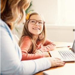 girl and adult at laptop computer