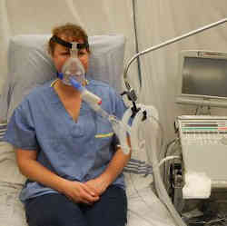 A patient receiving breathing assistance from a ventilator.