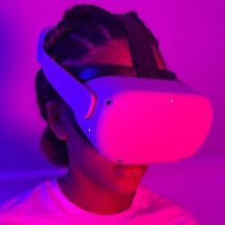 A young woman wears VR headset to explore metaverse.