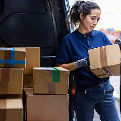 A courier checking a parcel for delivery.