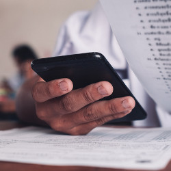 hand of test-taker holds a cellphone