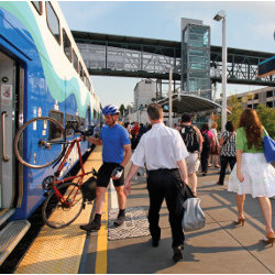 commuters board train at Seattle's Kent Station