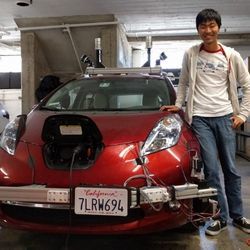 Aquarium CEO Peter Gao poses with an early Cruise self-driving car.