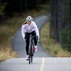 bicyclist riding on a country road