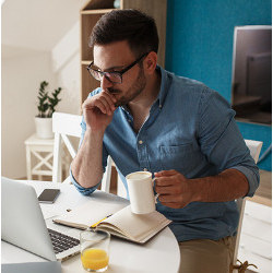 remote workers with coffee mug and book at laptop computer