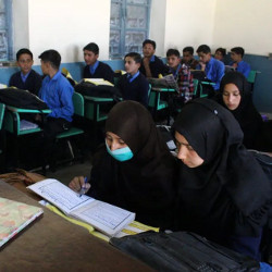 boys and girls seated on separate sides of a classroom