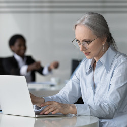 woman works at a laptop computer