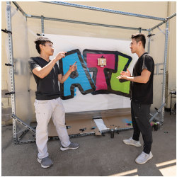 Gerry Chen and Michael Qian with an artwork printed by the GTGraffiti robot