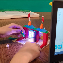 hands of student working with a LEGO Spike robotic kit