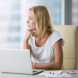 businesswoman stared out of office window