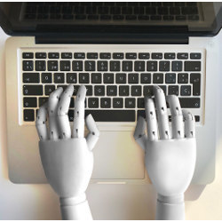 robotic hands on a computer keyboard