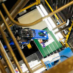 A Yaskawa robotic arm helps process small packages and letters at FedExs Memphis hub.