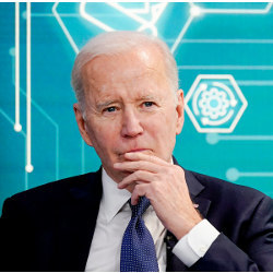 President Joe Biden in front of a chip-themed background