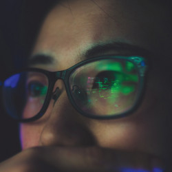 display illumination reflected in a woman's eyeglasses