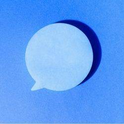 A social media speech bubble on a stark, blue background.
