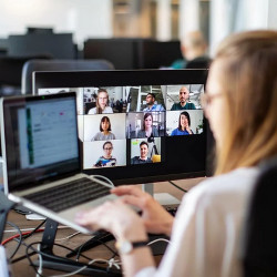 worker at laptop computer in a Zoom meeting