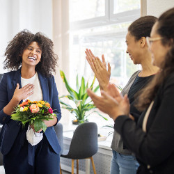 employee accepts flowers from co-workers