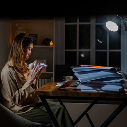 tired businesswoman working at night crumples a sheet of paper 