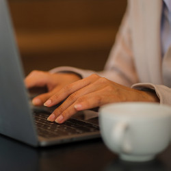 woman's hands on laptop computer keyboard