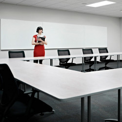 lone worker stands in empty conference room