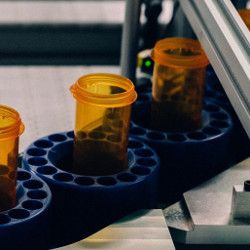 empty pill bottles move along a conveyor belt at Walgreens' automated drug filling center near Dallas