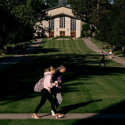 students walking by Herrick Chapel on the Adrian College campus