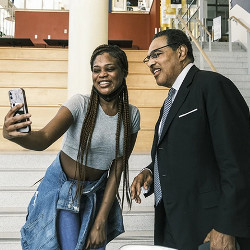 a student and Freeman Hrabowski pose for a selfie