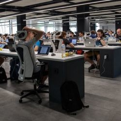 Students sit at their computers in a computer lab.