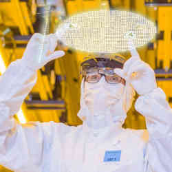 A technician examines the digital version of a silicon wafer