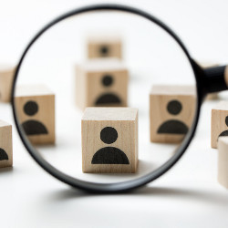 blocks with worker icons viewed through a magnifying glass