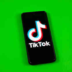 The TikTok logo on a smartphone screen.