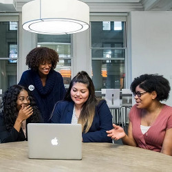 CEO Tarika Barrett with Girls Who Code program participants