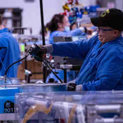 Employees build robots at an Amazon robotics innovation hub in Westborough, MA.