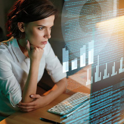 woman looks at a computer screen, graphs floating