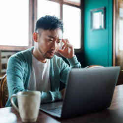 A Gen Z worker stymied by his laptop.