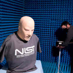 Jason Coder (at right) sets up an experiment in an anechoic chamber to use Wi-Fi to sense breathing.