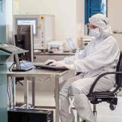 Researcher in a cleanroom.