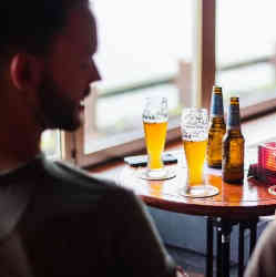 A man having a drink with friends.