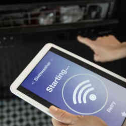 Launching the dishwasher from a smart handheld device. 