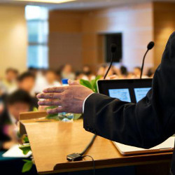 lecturer at a podium in a classroom