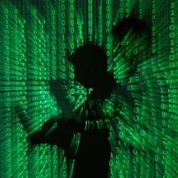Digital image illustration of a shadowy figure etched in a blurry field of data.