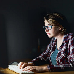 female at a keyboard and computer