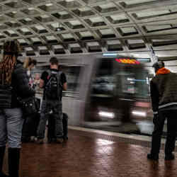 Riders await a train on the Washington D.C. Metro. 