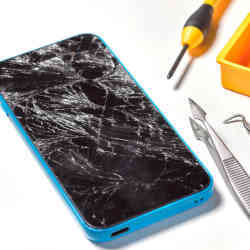 A smart phone with a broke screen awaits repair.