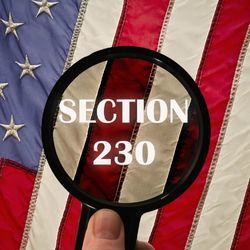 Digital illustration of a magnifying glass looking at the words "Section 230" atop an American flag.